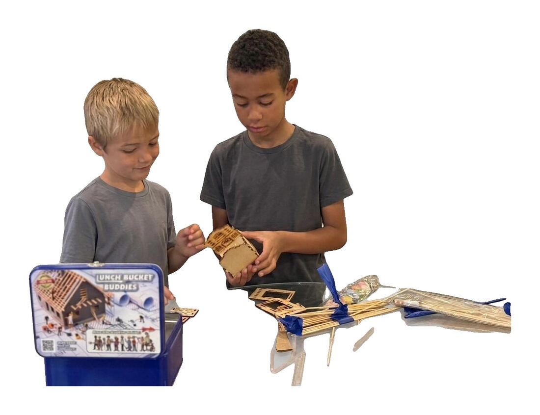 Two kids assembling the balsa model.