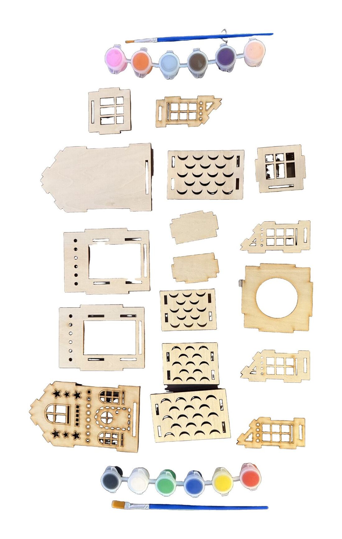 Every piece in Kit #1 laid out: laser-cut balsa panels, twelve pots of paint, and a brush.