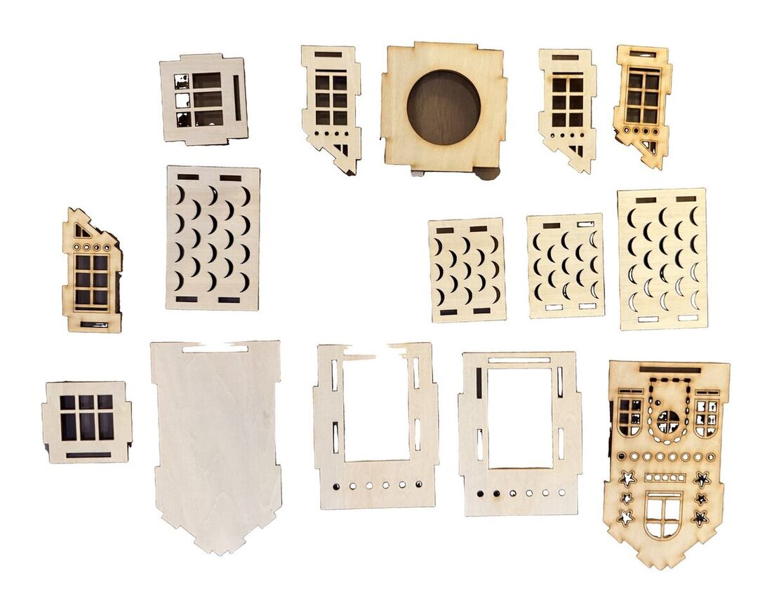 The laser-cut balsa pieces arranged in rows.